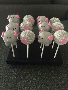 there are many cake pops that have been decorated with pink bows and hearts on them