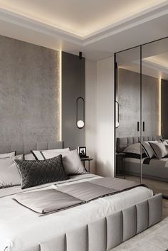 a large bed sitting next to a mirrored wall in a bedroom under a ceiling light