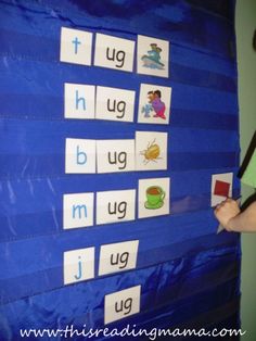 a person is writing letters on a bulletin board with blue tarp and black poles