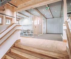 an office building with wooden stairs and glass walls