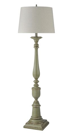 a table lamp with a white shade on it's base and a light bulb in the middle