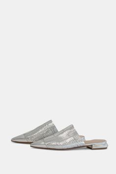 Strippy leather pointy toe mule in silver Silver Slip-on Mules For Party, Silver Slip-on Party Mules, Pointed Toe Party Mules With Leather Sole, Party Pointed Toe Mules With Leather Sole, Silver Pointed Toe Mules For Summer, Summer Silver Pointed Toe Mules, Party Mules With Pointed Toe And Leather Sole, Metallic Mules For Spring Evening Occasions, Silver Leather Mules For Party