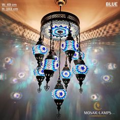 a chandelier hanging from the ceiling in a room with blue and white lights