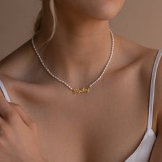 Delicate florals and pearls are a necessity for an elegant afternoon tea and brunch with the girls. Make the occasion feel even more special by taking the classic pearl necklace a step further by adding a personalized touch with our Minimalist Pearl Necklace featuring a custom dainty nameplate charm.• Material: High Quality Solid 925 Sterling Silver• Finish: Sterling Silver ∙ 18K Gold ∙ Rose Gold• Dimensions: Depending on your font choice, height sizes range from 3mm to 4mm lowercase SKU: MM-NM1 Pearl Name, Classic Pearl Necklace, Nameplate Necklace, English Letter, Waterproof Jewelry, Letter Pendants, Elegant Necklaces, Personalized Accessories, Name Plate