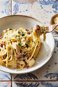 a white plate topped with pasta and meat