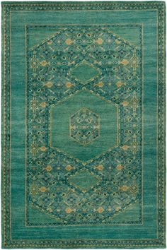 a green rug with an intricate design on the center and sides, in different colors