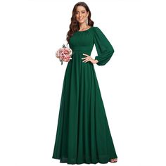 a woman wearing a long green dress with sleeves and a flower bouquet in her hand