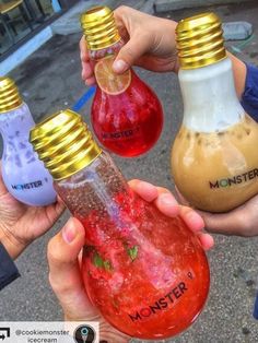 three people holding different colored light bulbs in their hands, one is yellow and the other is red