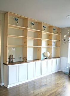 a living room filled with lots of wooden shelves