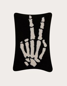 a black and white pillow with a hand print on it