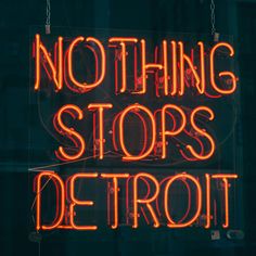 a neon sign that says nothing stops detroit