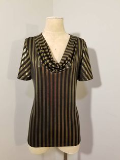 "++ BLACK & GOLD STRIPED TOP ++ 90's Does 70's Metallic gold and black striped Draped cowl neck No tags - would best fit a size L/XL In great vintage condition ✂ - - - Measurements laid flat: Pit to pit: 19.5\" Waist: 19\" Hips: 22\" Top to bottom: 26\" Let's be friends! @TheGirlSailYes @Covet.Vintage Facebook: www.facebook.com/TheGirlSaidYesVintage www.facebook.com/CovetCincinnati round rack" Retro V-neck Party Tops, Gold Fitted Disco Top, Vintage Gold Tops For Night Out, Gold Fitted Tops For Party Season, Fitted Gold Top For Holidays, Gold Disco Tops For Party Season, Gold Disco Top For Party Season, Cowl Neck Shirt, Tøp Aesthetic