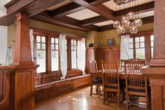 a large dining room with wooden furniture and windows