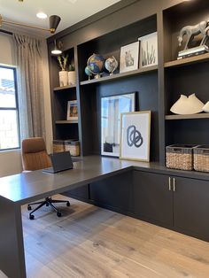 a home office with built - in shelving and desk