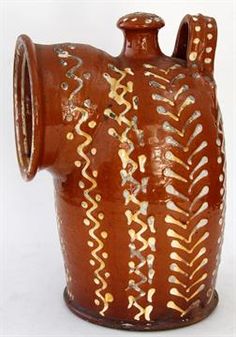 a brown vase with white designs on it