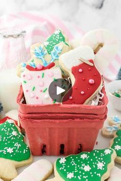 a basket filled with cookies and other holiday treats sitting on top of a white table