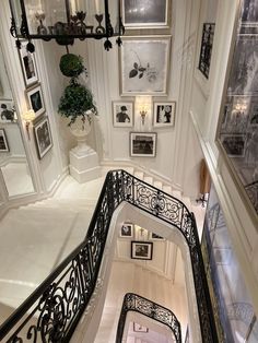 an ornate staircase with pictures on the wall