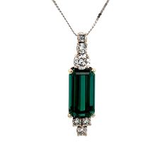 7.68 Carat Green Tourmaline & Diamond Pendant in White Gold Crafted in 14 karat white gold, this necklace features a striking emerald cut green tourmaline as the primary stone. The emerald cut adds a touch of elegance to the piece, while the four prong basket setting allows the stone to shine even brighter. Adding a touch of sparkle and sophistication are the round brilliant and old European cut diamonds, with a total weight of .56 carats. These natural diamonds have a beautiful G color and SI1 Luxury Green Emerald Cut Necklace, Elegant Emerald Cut Tourmaline Jewelry, Formal Fine Jewelry Emerald Necklace With Baguette Cut, Formal Fine Jewelry Baguette Cut Emerald Necklace, Formal Baguette Cut Emerald Necklace In Fine Jewelry Style, Formal Baguette Cut Emerald Necklace, Green Emerald Baguette Cut Necklace, Formal Emerald Cut Green Emerald Necklace, Formal Green Emerald Cut Emerald Necklace