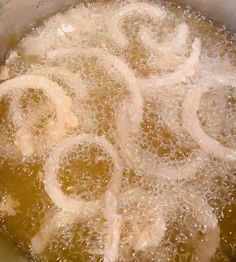 the food is being cooked in the pot on the stove top, and it looks to be boiling