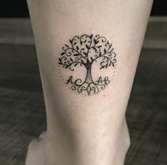 a small tree tattoo on the leg