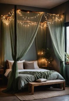 a canopy bed with lights hanging from it's sides and pillows on the floor