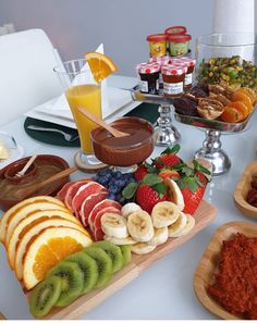 an assortment of fruits and desserts on a table