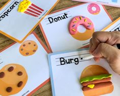 a person is writing on some doughnuts and donuts with the word burger