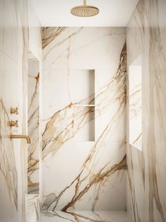 a bathroom with marble walls and flooring in white, gold and grey colors on the shower wall