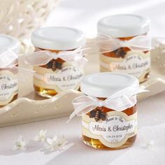 four jars of honey with labels on them