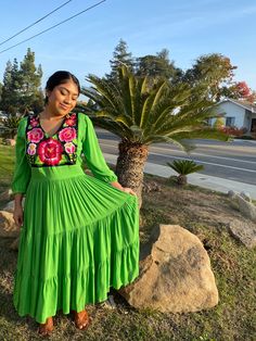 This stunning dress was hand embroidered by Oaxacan artisans. It is made out of rayon, it is extremely soft and cozy! This piece can fit a small or a size medium.  Model is a size S/M and 4'11. (Earrings not included) Green Bohemian Dress With Embroidered Hem, Bohemian Green Dress With Embroidered Neckline, Bohemian Green Dress With Embroidered Hem, Green Bohemian Embroidered Maxi Dress, Bohemian Green Maxi Dress With Floral Embroidery, Bohemian Maxi Dress For Fiesta, Bohemian Embroidered Dress For Fiesta, Bohemian Embroidered Maxi Dress For Fiesta, Bohemian Embroidered Dress For Cinco De Mayo Fiesta