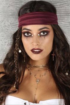 a woman with long hair wearing a headband and choker necklaces is posing for the camera