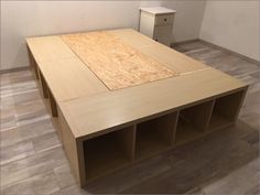 an unfinished table with shelves on the floor