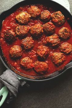 meatballs covered in marinara sauce in a skillet