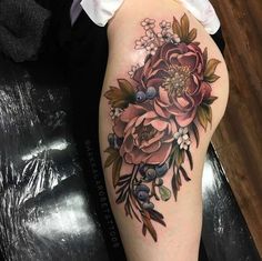 a woman's thigh with flowers on it