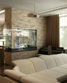 a living room filled with furniture and a large fish tank in the middle of it