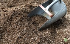 a shovel laying on top of a pile of dirt