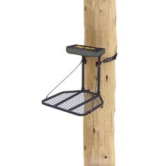 a wooden pole with a metal shelf attached to the side and a wire hanging from it