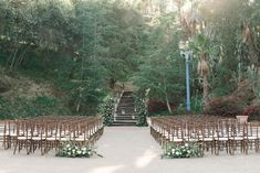 an outdoor ceremony set up with chairs and flowers