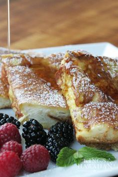 french toast with berries and raspberries on a white plate