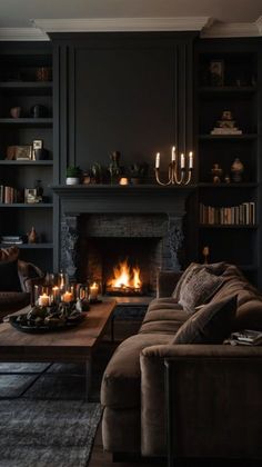 a living room filled with furniture and a fire place in the middle of the room