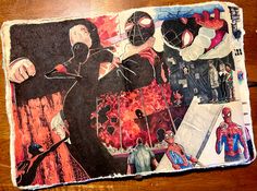 an altered photograph of spiderman and other characters on a piece of paper with scissors