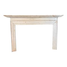 an old white fireplace mantel against a white background