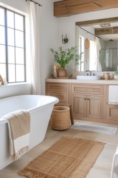 a white bath tub sitting next to a bathroom sink under a large mirror on top of a wooden cabinet