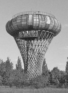 a large water tower sitting in the middle of a forest