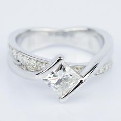 a white gold ring with a princess cut diamond