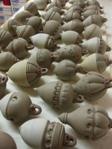 many clay heads are lined up on a table