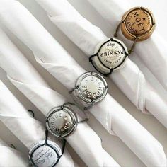 three watches sitting on top of each other near white napkins with writing underneath them