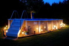 an inflatable swimming pool with lights around it and steps leading up to it