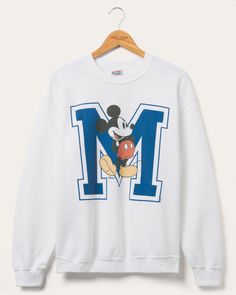 Hey Disney fans have you been looking for a new crewneck? Well search no further and check out our Mickey Big M Flea Market Fleece. Made out of super soft 50% cotton and 50% polyester fleece for a relaxed oversized fit. Also featuring a collegiate-esque vintage inspired Mickey Mouse graphic on the front of the fleece. This fleece has it all comfort, style, and flexibility.  Shop our Disney Collection HERE and Shop the rest of our Pop Culture Collection HERE. © Disney New England Patriots Sweatshirt, Distressed Sweatshirt, Vintage Details, Food Clothes, Vintage Clothing Men, Mens Fleece, Disney Outfits, 로고 디자인, Crop Sweatshirt