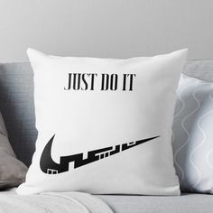 a pillow that says just do it with a black nike logo